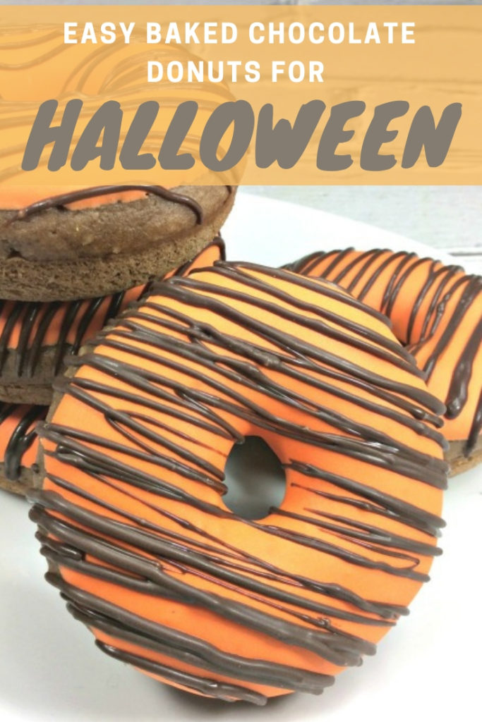 Make these Homemade Chocolate Donuts for Halloween.  The easy baked donut recipe includes orange icing and black stripes.  