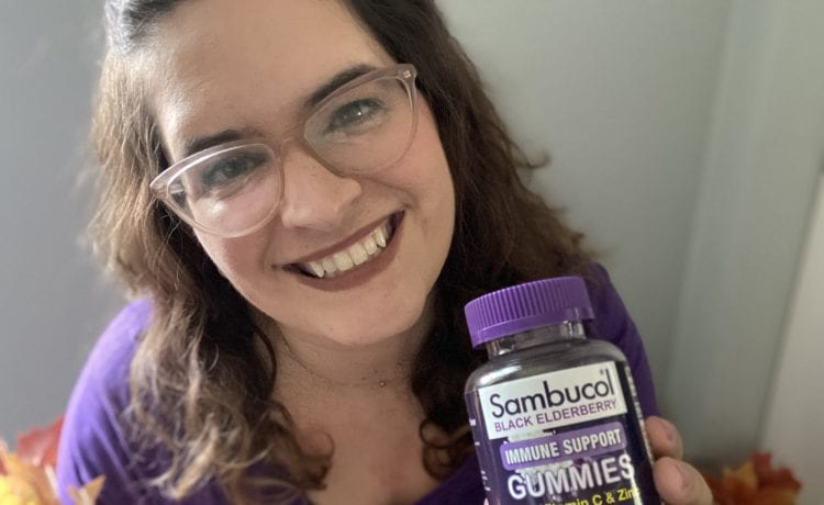 Woman Holding Sambucol Black Elderberry Gummies